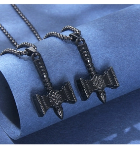 Detailed close-up of two black Thor's Hammer pendants with intricate Celtic engravings