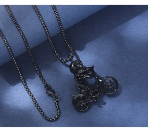 Close-up of hip hop skeleton motorcycle pendant on black round box chain with blue background