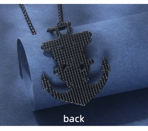 Close-up of black stainless steel anchor pendant back with mesh texture details