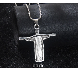 Vue détaillée du dos texturé d'un pendentif croix de Jésus argenté sur chaîne