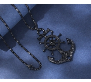 Detailed shot of nautical anchor and rudder pendant necklace in gunmetal black finish