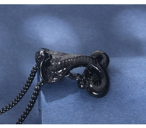 Macro shot of black mamba snake pendant with detailed scales and matching bead chain
