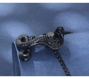 Macro shot of hip hop black cobra pendant in polished stainless steel with box chain