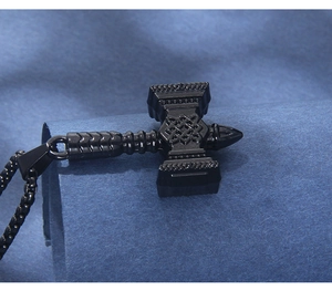 Macro shot of black stainless steel Mjölnir hammer pendant with Celtic knot engravings