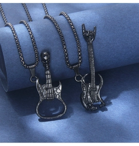 Detail of punk style skull guitar pendants in black finish with box chains on display