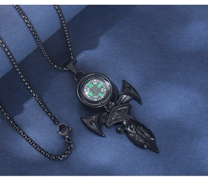 Detailed close-up of a black stainless steel compass pendant necklace with an eye relief