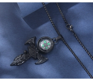 Macro shot of gothic black dagger pendant with integrated functional compass and box chain
