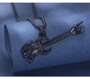 Detail of black punk guitar pendant featuring Xenomorph design and rock gesture on chain