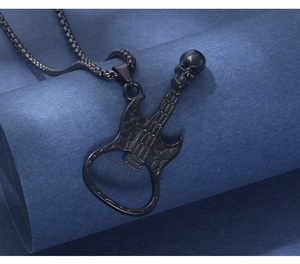Macro shot of black guitar pendant necklace with skull head and bottle opener function