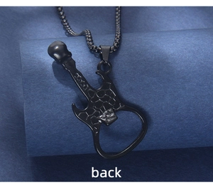 Macro detail of black guitar pendant with textured back surface and box chain link