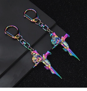 Detail of colorful metallic rose cross keychain with vibrant gradient rainbow finish