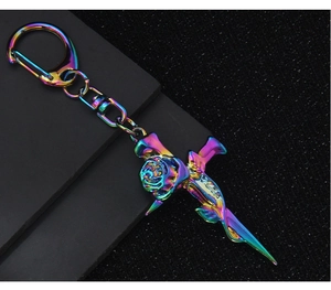 Macro shot of colorful rainbow plated metal cross and rose keychain with hook
