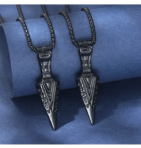 Detail of black stainless steel Valknut pendant with Nordic runes on a spearhead necklace
