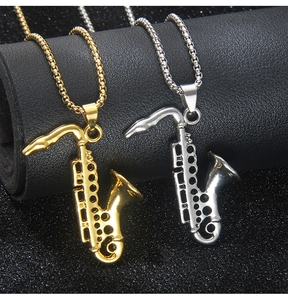 Close-up of gold and silver saxophone pendants on sturdy box chains for men