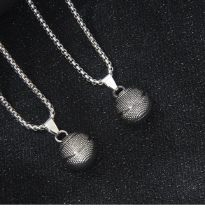 Detailed view of the 3D solid basketball pendant featuring fine texture and steel chain