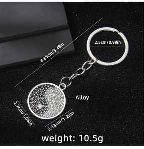 Close-up of Yin Yang Bagua keychain with silver alloy finish and sparkling rhinestones