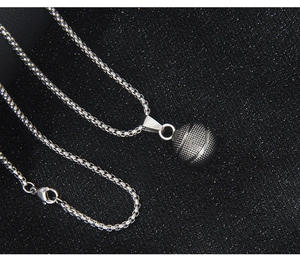 Macro shot of silver 3D basketball pendant with detailed texture on box chain