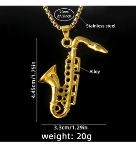 Macro shot of gold saxophone pendant with stainless steel chain on a black background