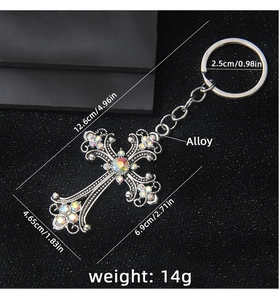 Detail showing vintage cross keychain with colorful rhinestones and alloy floral engraving