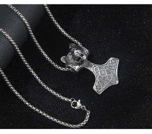 Détail du pendentif Viking Mjolnir avec tête de loup et gravures celtiques complexes