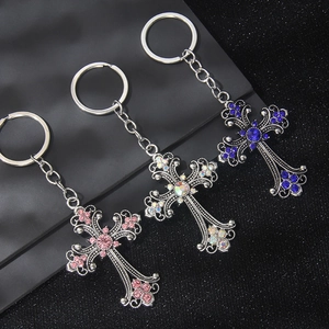 Gothic flower cross keychains with colorful rhinestones on a premium black display