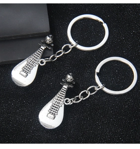 Macro detail of ancient silver pipa lute keychain and bottle opener made of zinc alloy
