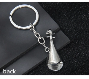 Detailed back view of a vintage silver lute musical instrument metal keychain