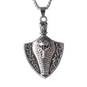 Vintage stainless steel shield pendant necklace featuring a cobra king embossed design