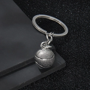 3D silver metal basketball keychain with realistic texture on a textured black surface