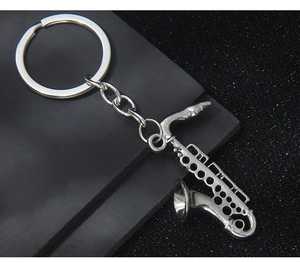 Macro shot of silver saxophone keychain details with polished metal finish and keys