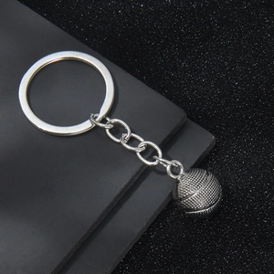 Vintage silver 3D basketball keychain pendant on a modern textured dark grey background