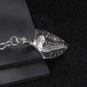Vintage cobra shield metal keychain with antique silver relief patterns in retro style