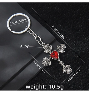 Macro view of gothic cross rose keychain with red heart gemstone and size annotations