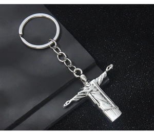 Macro shot of the polished silver Christ the Redeemer pendant on a sturdy metal keychain