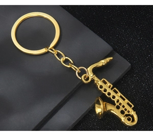 Macro detail of golden saxophone musical instrument keychain with polished metal finish