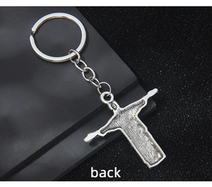 Detailed back view of vintage silver Christ the Redeemer cross keychain pendant