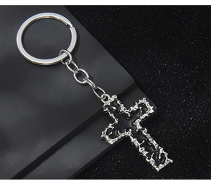 Detailed macro view of the silver cross keychain with black enamel center inlay