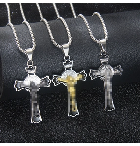Close-up of gothic stainless steel cross necklaces with black enamel and Jesus detail