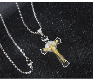 Macro detail of gothic stainless steel cross necklace with black enamel inlay and box chain