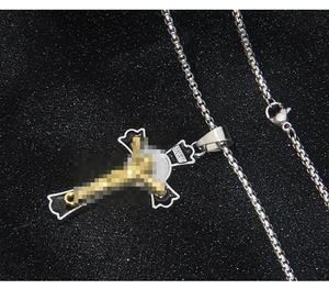 Macro shot of gothic stainless steel cross necklace with black enamel and INRI inscription