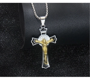 Detail of gothic stainless steel silver cross necklace with gold Jesus crucifix pendant