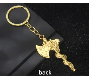Detailed view of the golden Viking axe keychain back showing textured metal alloy finish