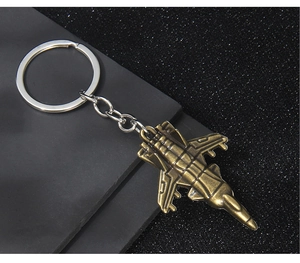 Macro detail of vintage bronze fighter jet metal keychain with intricate mechanical wings
