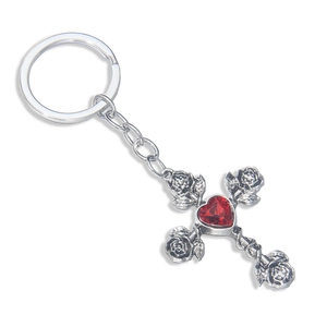 Gothic silver cross keychain with 3D roses and a central heart-shaped red gemstone