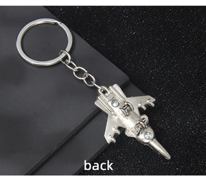 Detailed bottom view of the vintage metal fighter jet keychain with polished wing structure