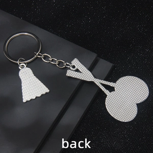 Silver metal badminton keychain with heart charms and textured anti-slip back finish