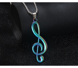 Détail du collier avec pendentif clé de sol arc-en-ciel sur une texture en cuir noir