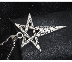 Close-up of vintage steel Viking pentagram pendant with Eye of Horus on dark leather