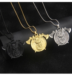 Three Viking warrior pendant necklaces in black, gold, and silver on leather display stand