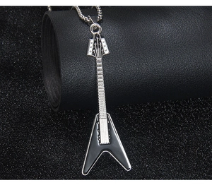 Macro shot of a Flying V guitar pendant with black enamel finish and silver braided chain